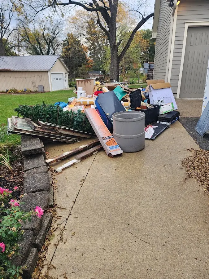 Dumpster being loaded with debris for Commercial Dumpster Rental in Rendon